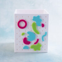 bits and bobs charms snappy pots magenta aqua lime on white pen holder