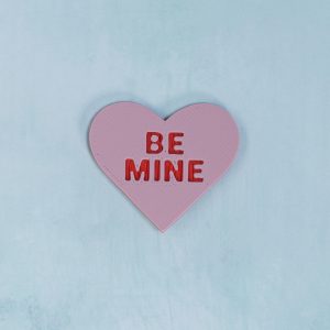 red on pink be mine conversation heart