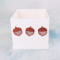 Three acorns on white snappy pot