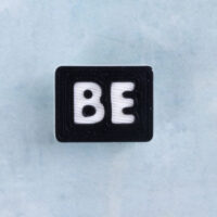 Black and white word charm be
