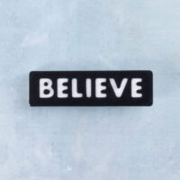 Black and white word charm believe
