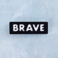 Black and white word charm brave