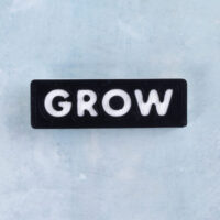 Black and white word charm grow