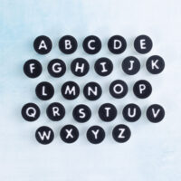 Black circle letter charms