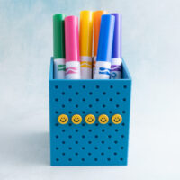 Cerulean teal pen holder snappy pot with small smiley face charm on charms