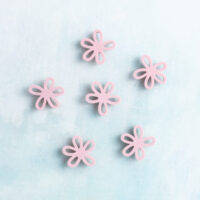 Small pink flower charm on charms back