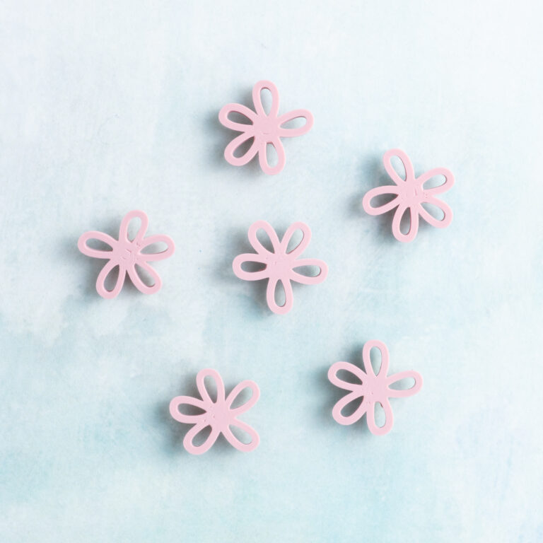 Small pink flower charm on charms back