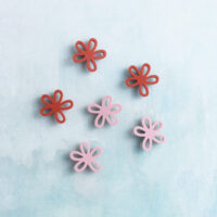 Small pink red flower charm on charms front