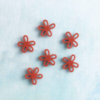 Small red flower charm on charms