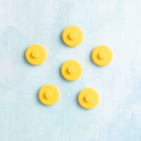 Small smiley face charm on charms yellow back