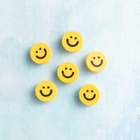 Small smiley face charm on charms yellow black