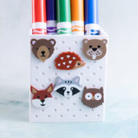 fox bear beaver racoon porcupine owl animal charms on white pen holder with markers