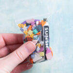 assorted snappy pots charms in bag being held