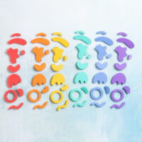 Squiggle shapes charms in six rainbow colors