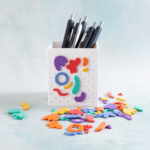 squiggle shapes rainbow charms on pen holder