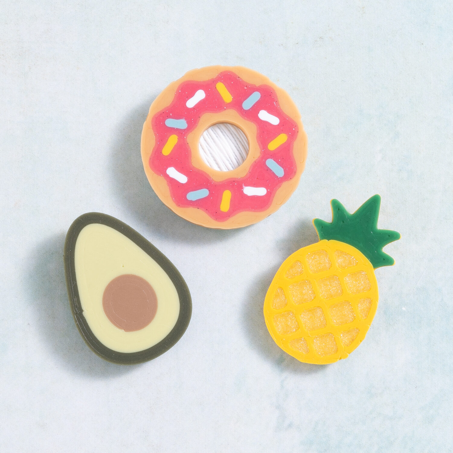 Donut, avocado, and pineapple food charms from Snappy Pots