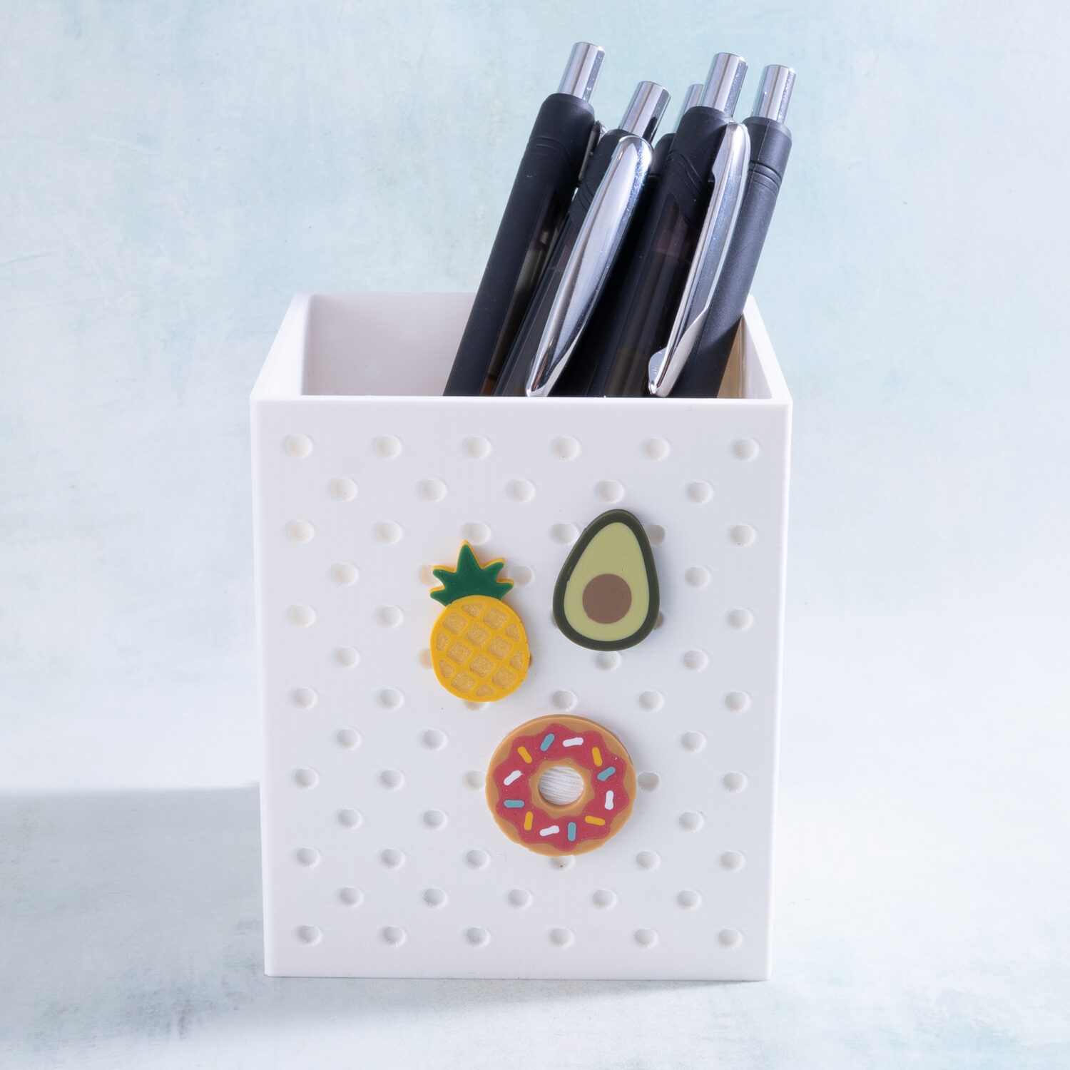 Pineapple, avocado, and donut charms on a Snappy Pots pen holder