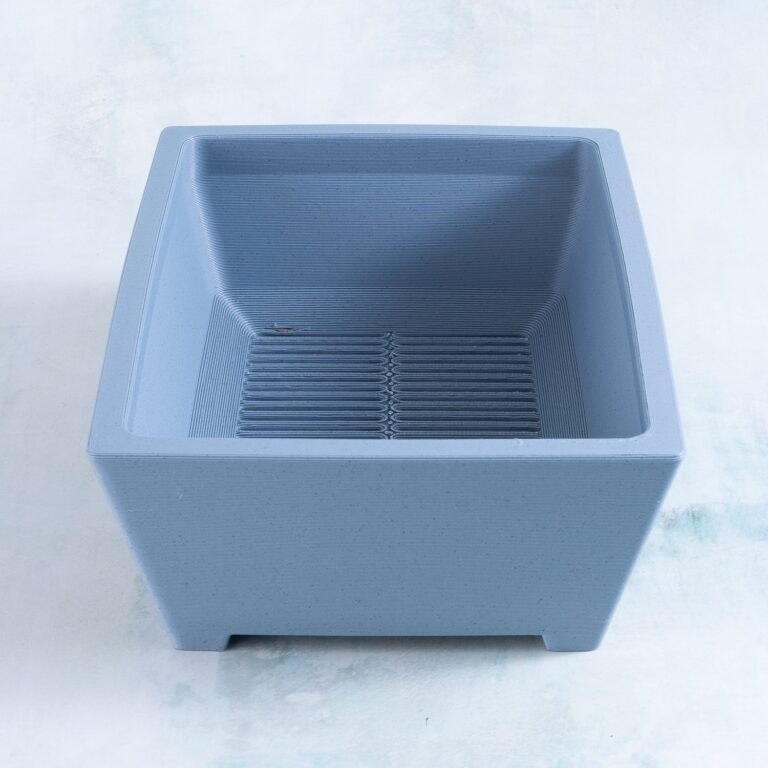 Large rectangle 3D printed succulent planter in haze gray, angled view showing the sloped interior and drainage grate