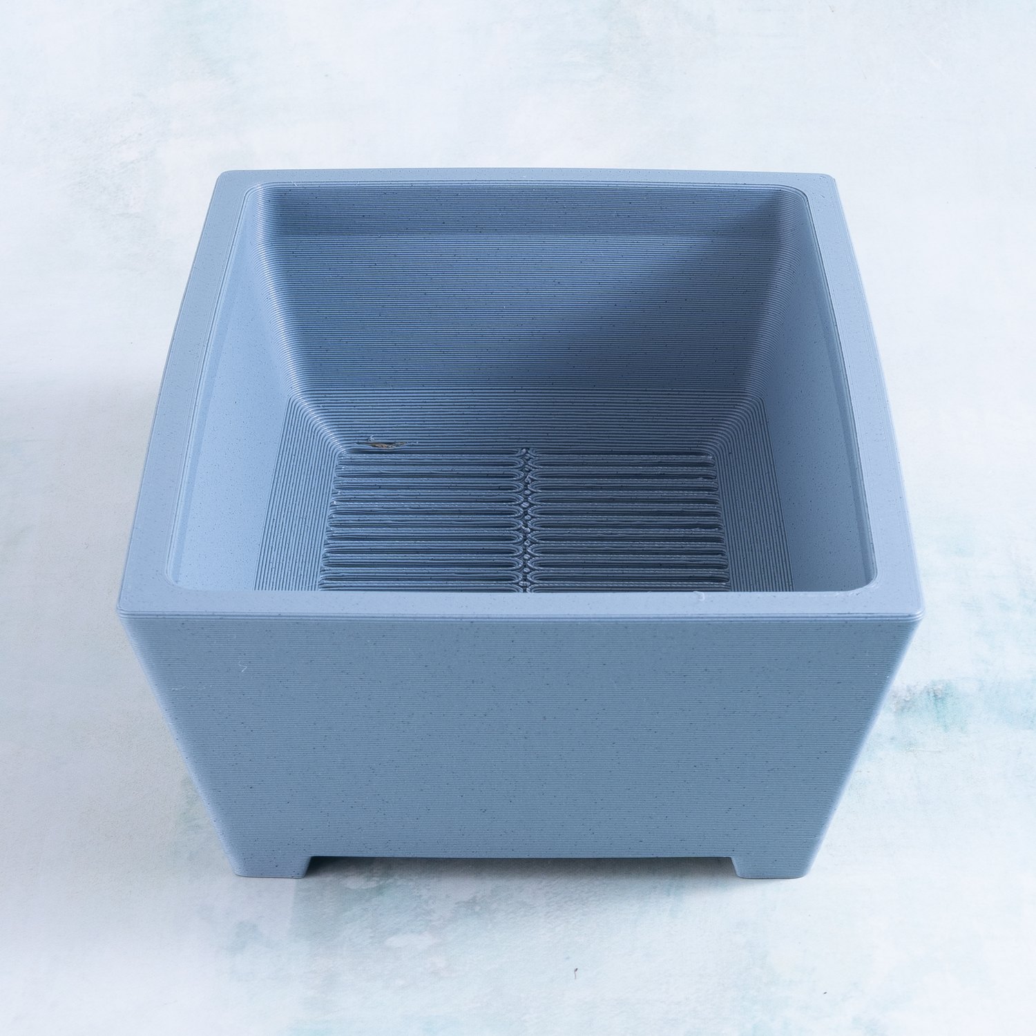 Large rectangle 3D printed succulent planter in haze gray, angled view showing the sloped interior and drainage grate