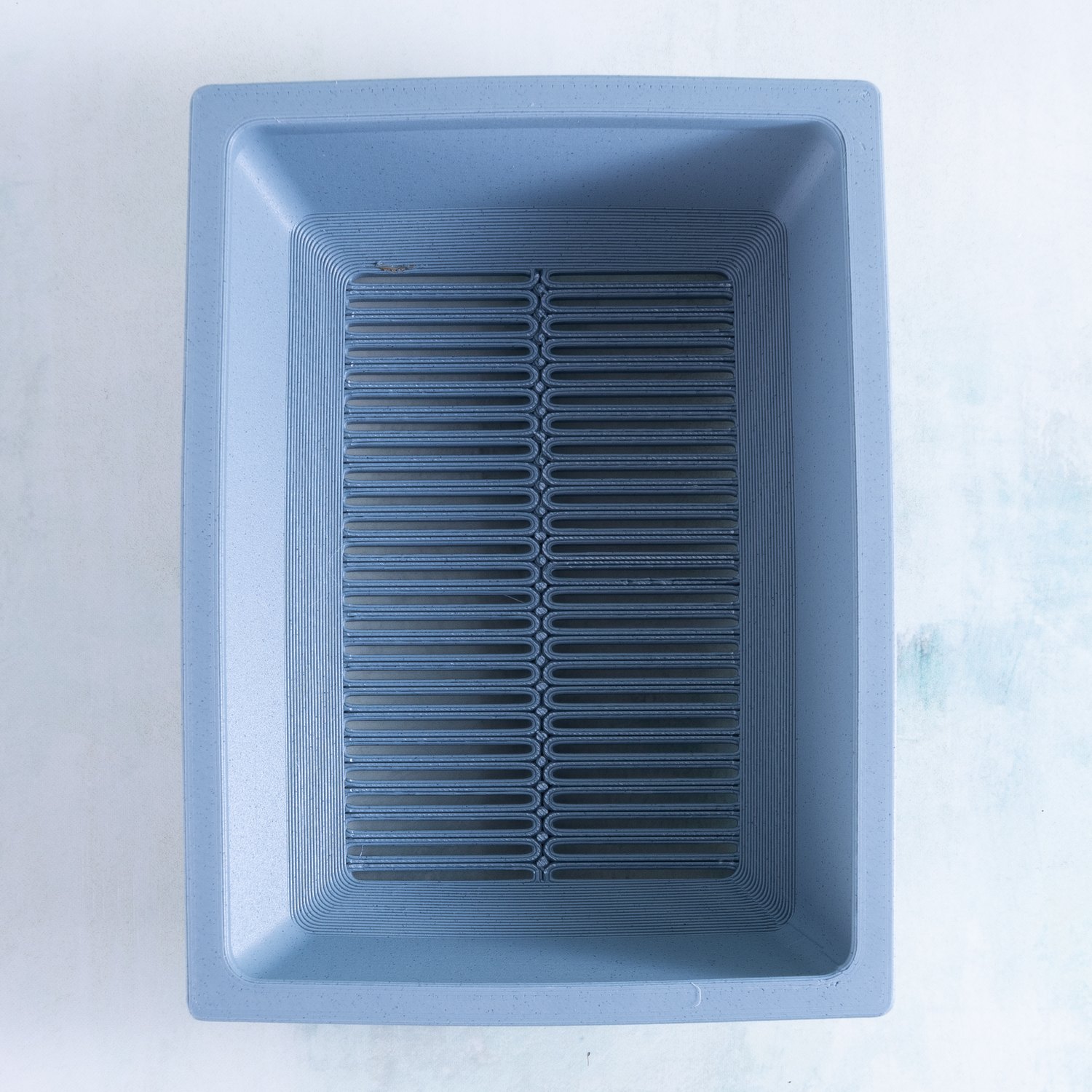 Top view of the large rectangle 3D printed succulent planter in haze gray showing the full drainage grate
